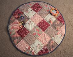 a round patchwork table top on the floor with various items laid out in it