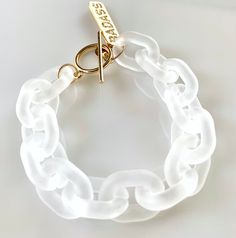 "Survive this past year like a badass? Searching for a gift for that badass in your life? This might just be the perfect gift! White frosted acrylic links are combined with a toggle clasp and CZ pave \"BADASS\" charm (gold or silver). For an average size wrist, we recommend a length of 8 3/4 inches on this design (so it has some room to move around easily), but it can custom ordered to any desired length (just make a note in the personalization section if you would like a different length). This Trendy White Plastic Bracelets, Trendy White Plastic Bracelet, White Plastic Bracelets As Gifts, White Plastic Bracelets For Gift, Leopard Face, Frosted Acrylic, Alexandria Va, Eyeglass Chain, Bracelet Clasps