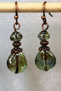 Gorgeous green dangle Czech glass earrings with hints of brown and a special luster. Best Seller! Unique Green Teardrop Beaded Earrings, Czech Glass Teardrop Earrings With Ear Wire, Beaded Glass Teardrop Earrings, Glass Beaded Teardrop Earrings, Teardrop Beaded Glass Earrings, Bohemian Teardrop Glass Jewelry, Teardrop Czech Glass Dangling Beads Earrings, Bohemian Teardrop Glass Earrings, Nickel-free Teardrop Czech Glass Earrings