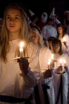 a group of people holding candles in their hands