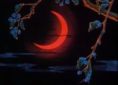 a red moon is seen in the night sky behind a tree branch with blue berries on it