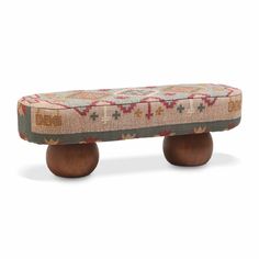 an upholstered bench with wooden legs