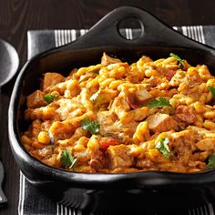 a skillet filled with food sitting on top of a table