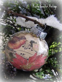 an ornament hanging from a tree branch with music notes on it's side