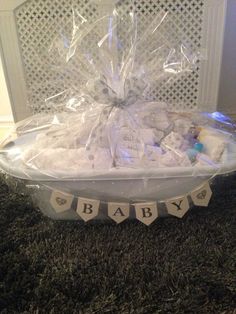 a basket filled with baby items sitting on top of a carpeted floor next to a wall