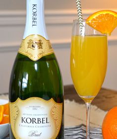 a bottle of korbel champagne next to an orange slice