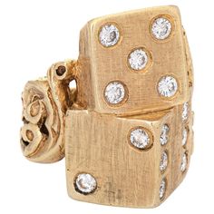 Finely detailed vintage diamond dice ring crafted in 14 karat yellow gold (circa 1970s). 13 round brilliant cut diamonds total an estimated 0.65 carats (estimated at H-I color and VS2-I1 clarity). The elaborate and beautifully detailed ring highlights a 6, 5 & 2 dice, perched on an intricate scrolled band. The inner band is engraved "I Love Big Daddy". The ring is a great example of 1970s era jewelry when big, bold pieces took center stage. The ring has a hefty feel on the finger at 22.1 grams. The low rise ring (6mm - 0.23 inches) sits comfortably on the finger. The ring is in very good condition. We have not cleaned it in order to preserve the patina and collector value. Particulars: Weight: 22.1 grams Stones: 13 round brilliant cut diamonds total an estimated 0.65 carats (estimated at H Jackpot Candles Rings, Dice Ring, 1970s Jewelry, Detailed Ring, Ring Crafts, 70s Vintage, Center Stage, Antique Jewellery, Vintage Diamond