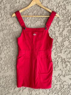 "Brand new tag still attached red jean Dickies overall dress. Women's Size XS 97% Cotton 3% Spandex. The material has a tiny bit of stretch to it.  The dress has 6 pockets. adjustable overall straps, and a zipper going down the back for easy slip-in. Super cute! Measurements laying flat Armpit to armpit 14.5\" (29\" total) Across the waist 13\" (26\" total) Total length of the dress is 32\" at its longest the straps are adjustable so its 27\" at its shortest. Items are shipped out within 1-2 bus Red Denim Dress, Red Cotton Overalls For Spring, Slim Fit Sleeveless Shortalls With Pockets, Fitted Red Overalls, Fitted Sleeveless Shortalls With Pockets, Casual Red Cotton Shortalls, Casual Fitted Knee-length Pinafore Dress, Casual Knee-length Fitted Pinafore Dress, Fitted Sleeveless Pinafore Dress With Pockets