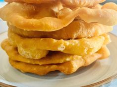 a stack of doughnuts sitting on top of a white plate