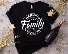 a black t - shirt with the words warning family trip in progress printed on it