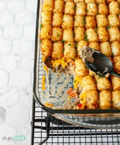 a casserole dish with tater tots in it on a cooling rack