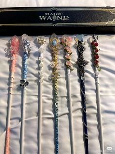 the wands are lined up in a row on top of each other with different designs