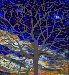 a stained glass window with a tree in the foreground