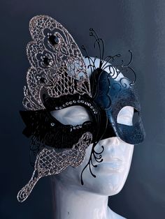 This glittering mask takes on the shape of a butterfly, symbolizing transformation and grace. The striking contrast of black and silver exudes an air of opulence and charm, while shimmering rhinestones adorn the mask. Whether you're attending a grand masquerade ball or a themed gala this mask ensures you'll be the center of attention.


Age Group/Gender - Adult/Women

Size/Type - One size fits all adults

Mask Color - Black/Silver

Mask Material - Polyresin and laser cut metal Masquerade Mask With Glasses, Masquerade Mask Design, Masquerade Mask Silver, Butterfly Masquerade Mask, Butterfly Masquerade, Mask Butterfly, Vampire Mask, Black Masquerade, Black Masquerade Mask