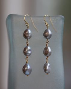 These are a wearable pair of freshwater pearl earrings. Using gold filled ear-wires, I have attached wire wrapped baroque freshwater pearls that are a wonderful shade of silvery peacock.  To the Lucky Buyer of these earrings: Wear them well and often! Baroque Pearl Dangle Earrings, Gold Tahitian Pearl Earrings Gift, Gold Tahitian Pearl Drop Earrings, Natural Stone Earrings Handmade, Natural Stone Earrings, Freshwater Pearl Earrings, Pearl Dangle Earrings, Baroque Pearl Earrings, Freshwater Pearls Earrings