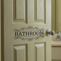 a bathroom door with the word bathroom on it's side and a sink in the background