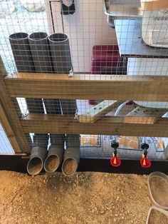 the inside of a caged in area with several different types of pipes and other items