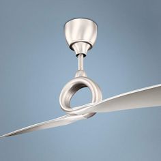 a silver ceiling fan with a light on it's blades and a blue sky in the background