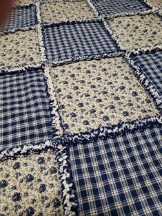 a blue and white quilt on the floor