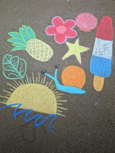 the chalk drawing is on the ground with crayons