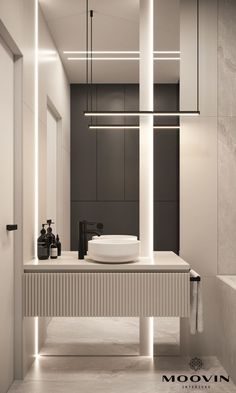 a bathroom with a sink, mirror and lights on the wall above it in black and white