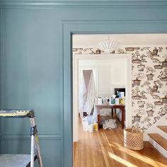 a room with blue walls and wooden floors