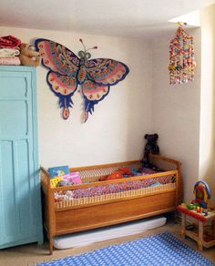 a child's room with a bed, dresser and toys