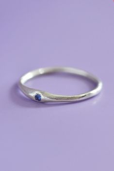 The Siyum gem ring is a true minimalist piece, a fine seamless round band is hand brushed finished allowing a contemporary aesthetic. Perfect for everyday, once you take it off you won't take it off! A petite round blue Sapphire adds a beautiful detail and personalised touch. Use the drop down to select your ring size.If you are unsure of your ring size refer to our size guide. Please select your ring size carefully, and reach out if you have any questions. DetailsSterling Silver Handcrafted in Blue Minimalist Promise Ring, Minimalist Blue Promise Rings, Minimalist Sapphire Ring With Bezel Setting For Everyday, Minimalist Birthstone Ring With Tension Setting, Minimalist Everyday Sapphire Ring, Minimalist Sapphire Ring With Round Band For Promise, Modern Sterling Silver Birthstone Ring For Everyday, Minimalist Blue Sapphire Ring For Everyday, Adjustable Minimalist Sapphire Promise Ring