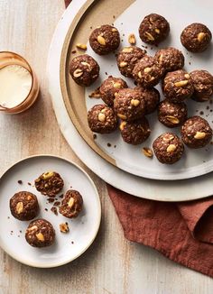 a plate full of cookies next to a glass of milk