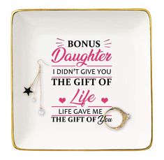 a plate with a ring on it that says,'bonus daughter i didn't give you the gift of life