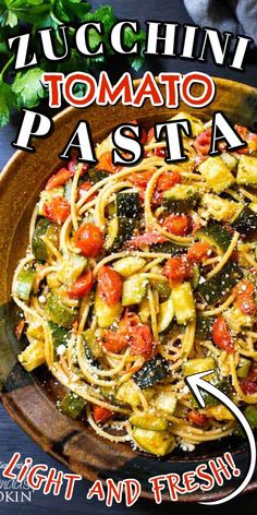 a plate of pasta with tomatoes and zucchini