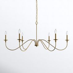 a gold chandelier with five lights hanging from it's center and four arms