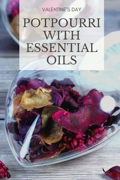 a bowl filled with purple flowers on top of a wooden table next to a spoon