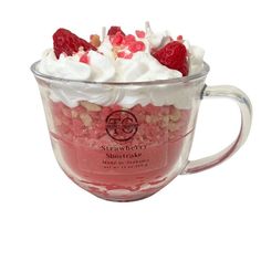 a cup filled with whipped cream and raspberries