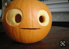 a carved pumpkin with eyes and nose on a table