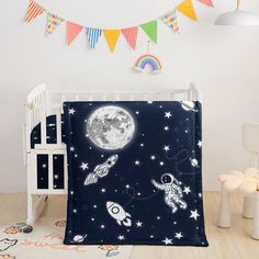 a child's room with a crib bed and wall hangings