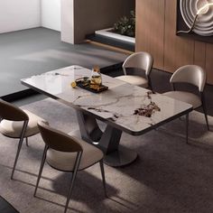 a marble dining table with four chairs around it