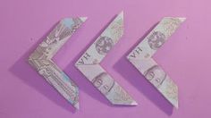 three origami arrows on a pink background with one arrow cut in half and the other made out of money