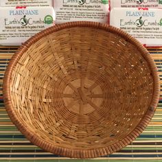 a wicker basket sitting on top of a table next to three packages of soap