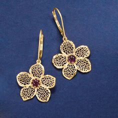 Ross-Simons - Italian .90 ct. t. w. Garnet Flower Drop Earrings in 14kt Yellow Gold. Embrace the natural beauty of spring by adding these flourishing flowers to your look all year long. Crafted in Italy, the elegant openwork flowers are dazzled with .90 ct. t. w. garnet centers. Diamond-cut, textured and polished 14kt yellow gold. Hanging length is 1 3/8". Leverback, garnet flower drop earrings. Garnet birthstones are the perfect gift for January birthdays. Elegant Yellow Gold Clip-on Flower Earrings, Formal Flower-shaped Clip-on Jewelry, Formal Pierced Flower-shaped Jewelry, Formal Pierced Flower Shaped Jewelry, Formal Flower-shaped Pierced Jewelry, Formal Flower Shaped Clip-on Jewelry, Yellow Gold Flower-shaped Clip-on Jewelry, Pierced Flower-shaped Earrings For Formal Occasions, Formal Gemstone Flower Earrings