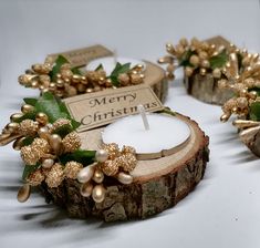 three wooden slices with christmas decorations on them and a candle in the middle that says merry christmas