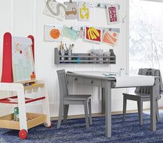 a child's desk and chair in a room with blue carpeted flooring