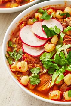 a white bowl filled with meat and vegetables