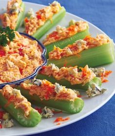 celery sticks filled with chicken salad and garnished with parsley