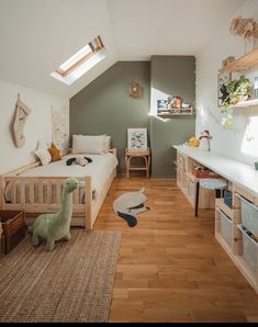 a child's bedroom with wooden floors and green walls, white bedding and shelves