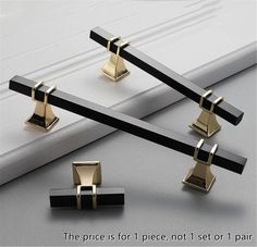 three pieces of black and gold jewelry sitting on top of a white surface with the words, the price is for 1 piece not 1 set or 1 pair