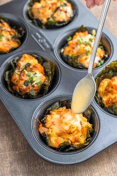 someone spooning some food out of a muffin tin