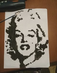 a piece of paper with a drawing of a woman's face on it