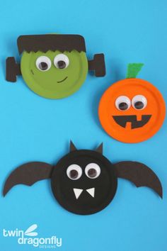 three paper plates decorated to look like halloween decorations