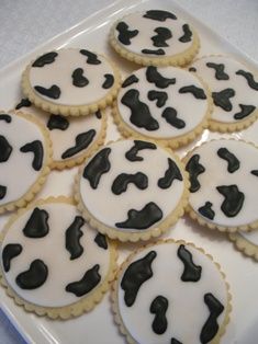 cookies decorated with black and white designs on a tray